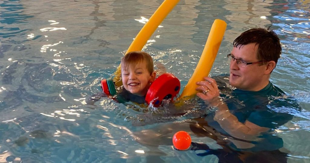 swimming lesson with aid